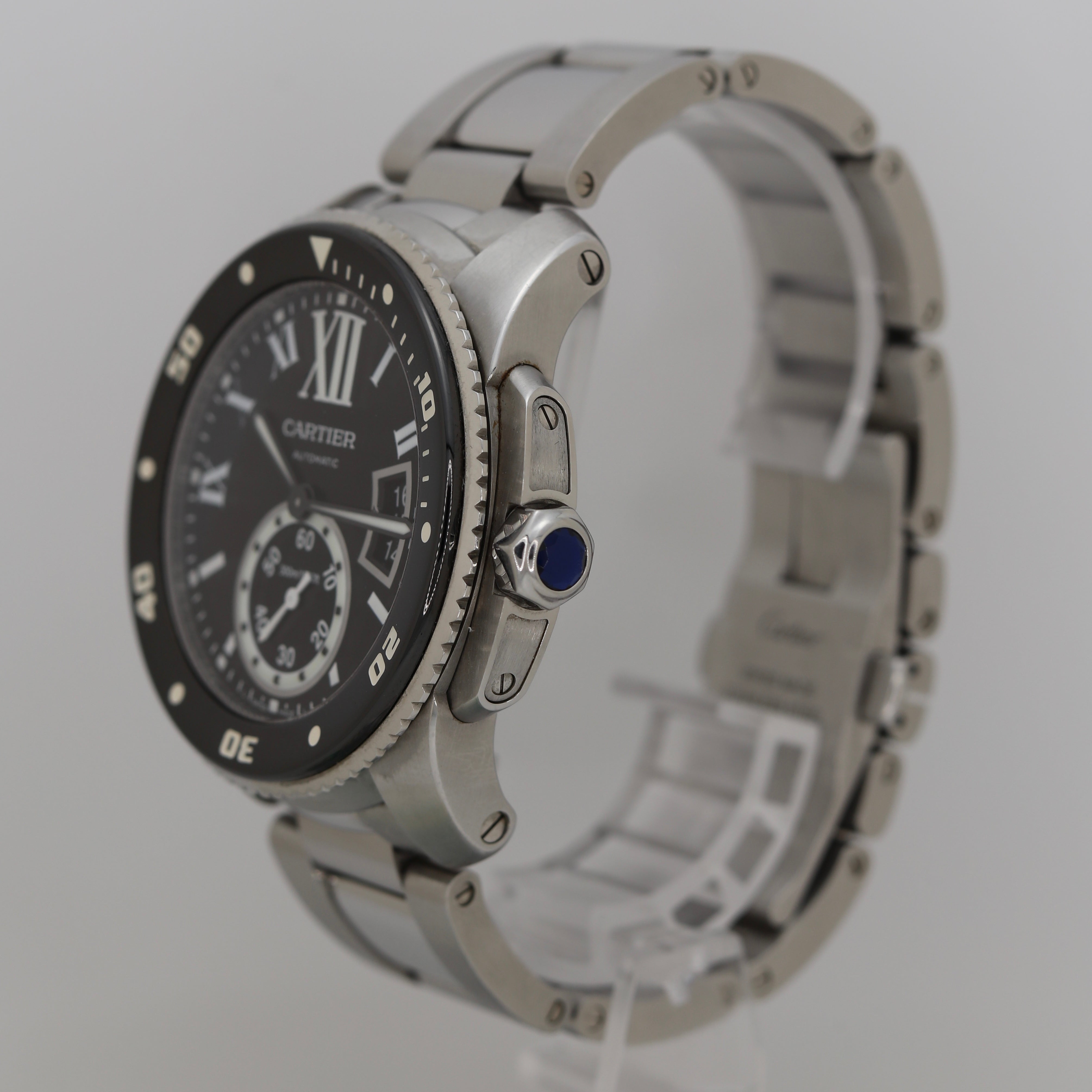 Right side view of Cartier Calibre de Cartier Diver 3729 showing screw-down crown with blue sapphire cabochon