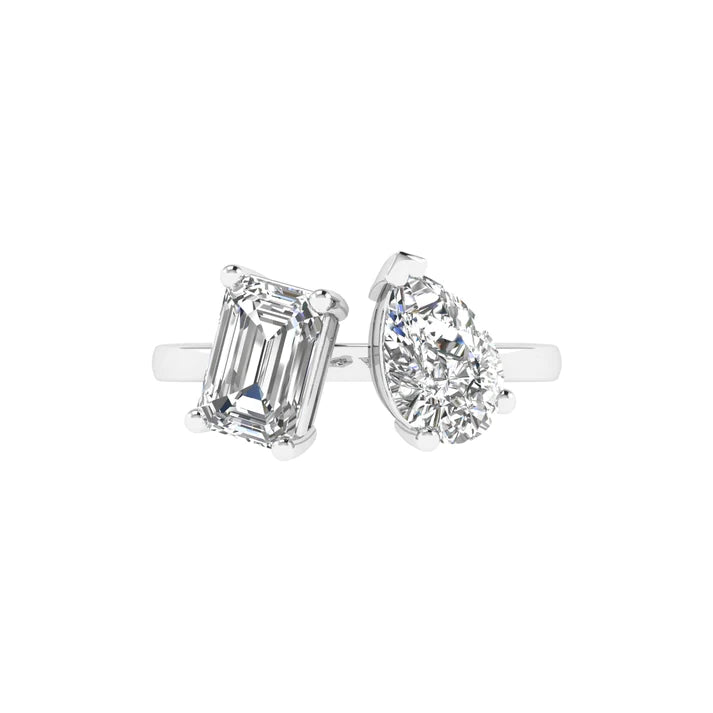 Emerald and pear diamond Toi et Moi ring featuring an elegant pairing of an emerald-cut diamond and a pear-shaped diamond, set in 14k