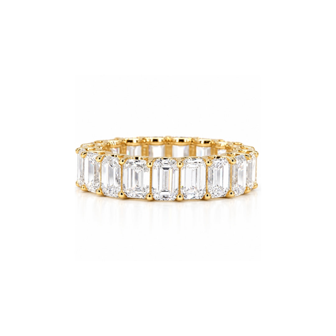 Emerald cut diamond eternity band in yellow gold with matched 4x3mm stones in a shared-prong setting