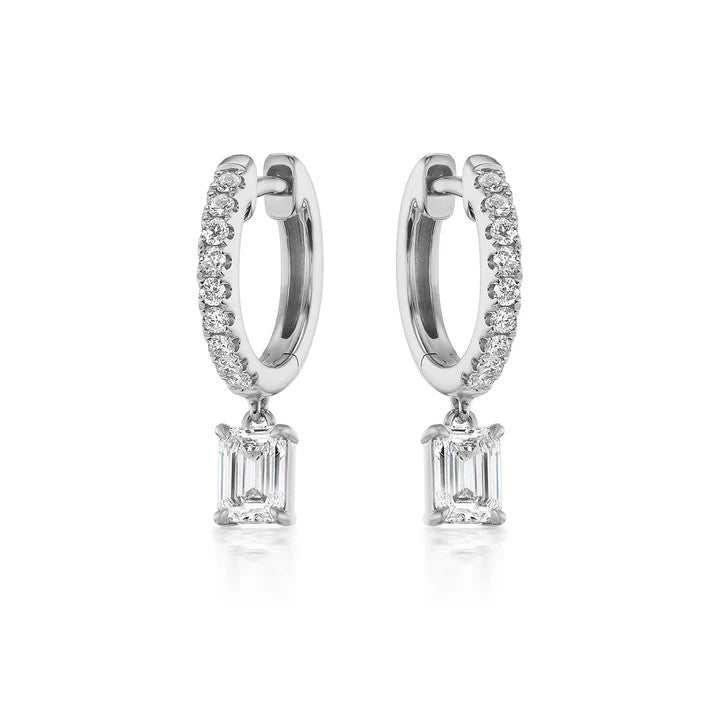 Huggie diamond earrings featuring sleek diamond-encrusted hoops with a dangling emerald-cut diamond, crafted in 14k