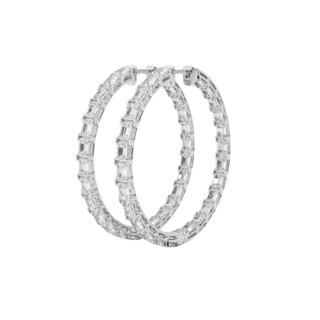 A pair of inside-out hoop earrings featuring sparkling emerald-cut diamonds, designed for elegance and maximum brilliance.
