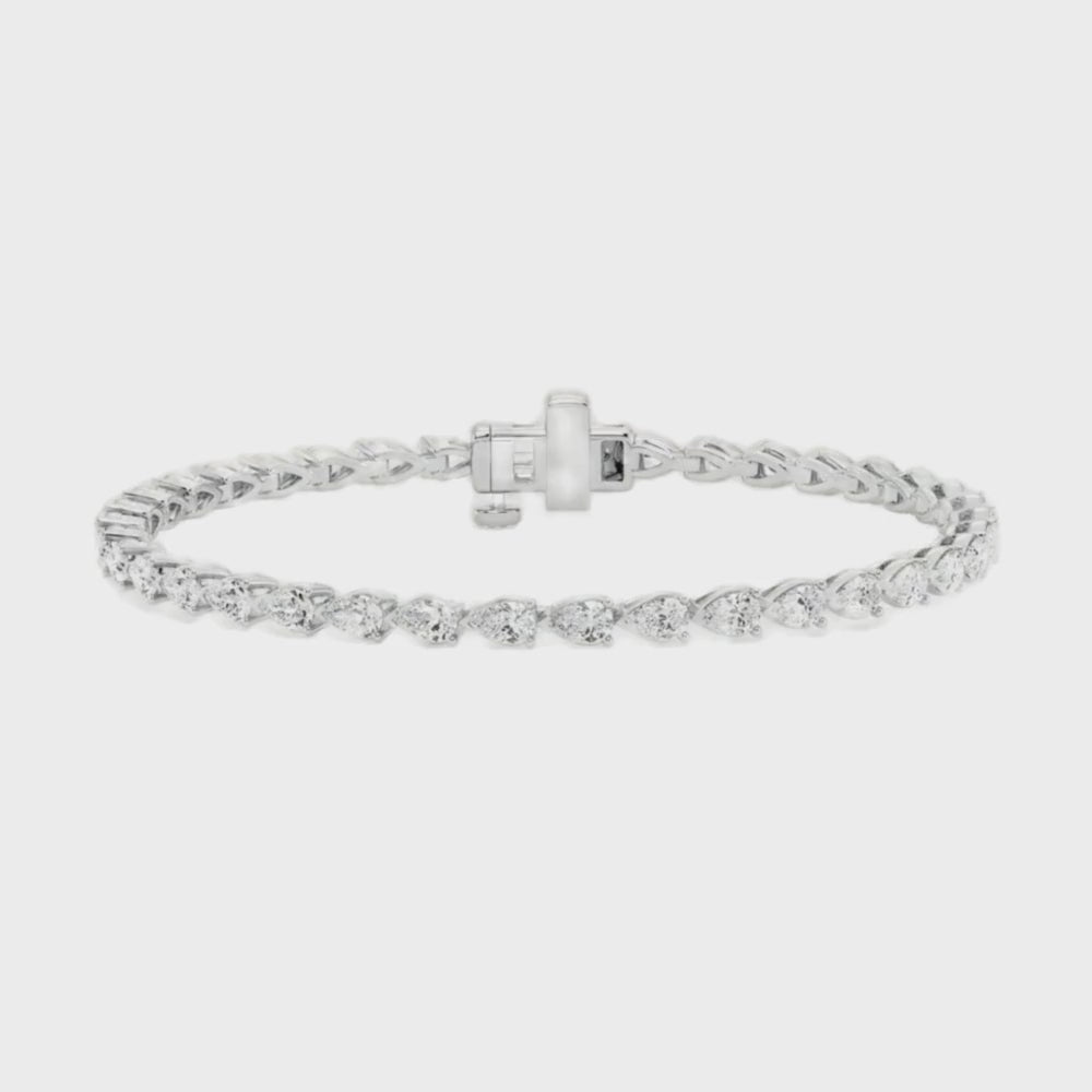 Pear diamond east to west tennis bracelet featuring 4.5 carats of pear-shaped diamonds in a modern design, set in 14k