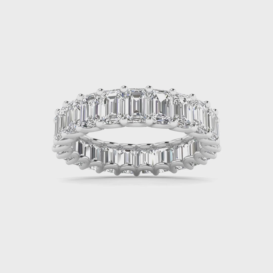 Emerald cut diamond eternity band featuring a continuous circle of radiant emerald-cut diamonds