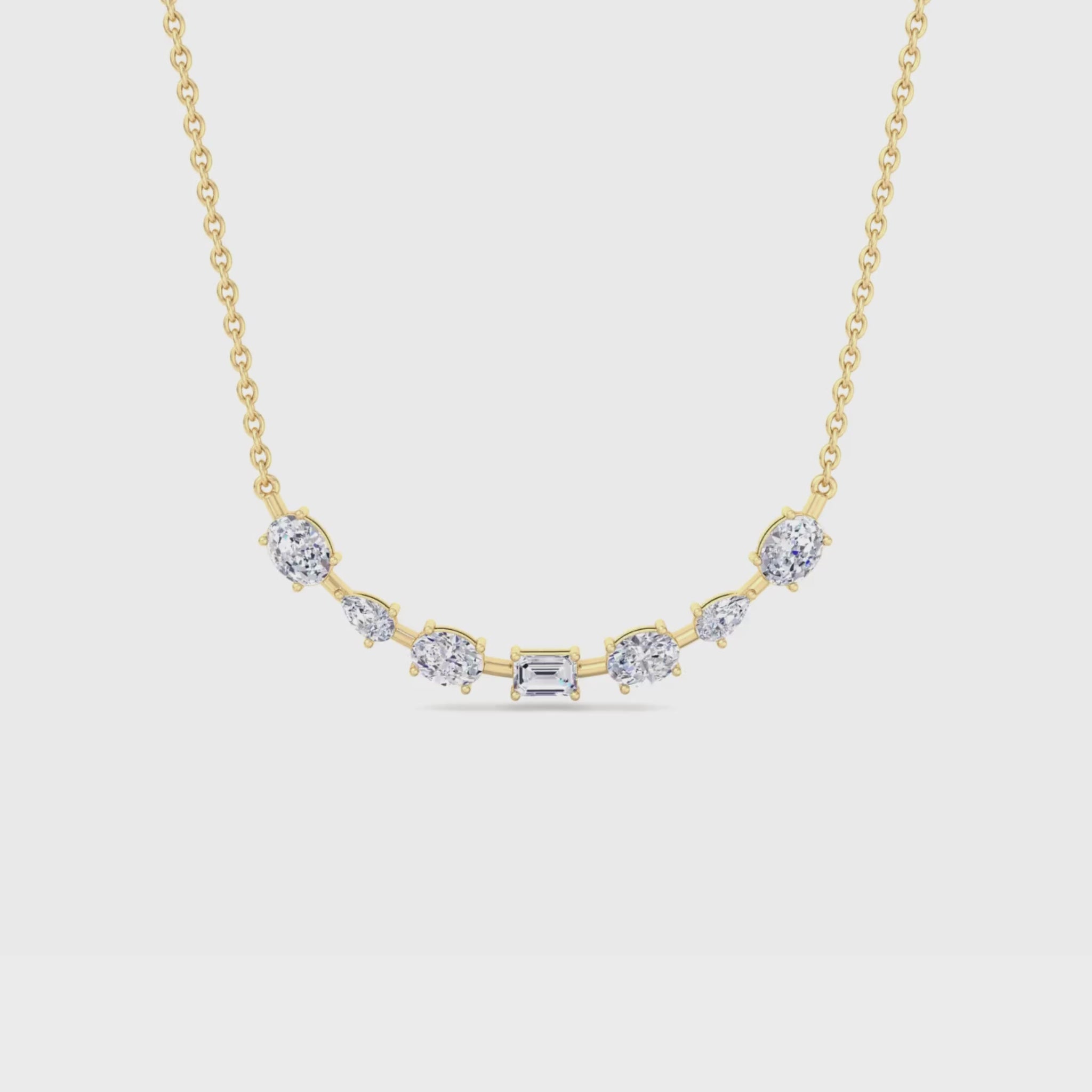 14K gold smile necklace featuring oval, pear, and emerald-cut diamonds in a curved design for a radiant and elegant look.