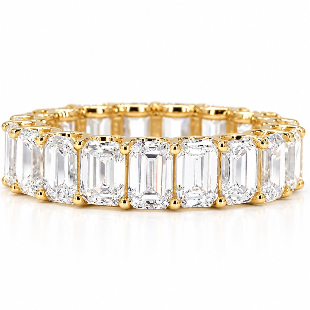 Emerald cut diamond eternity band in yellow gold with matched 4x3mm stones in a shared-prong setting zoomed