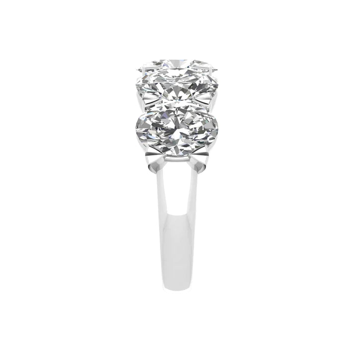 Five-stone ring featuring 5 carats of oval cut diamonds, elegantly set in a sleek band for a timeless and luxurious look