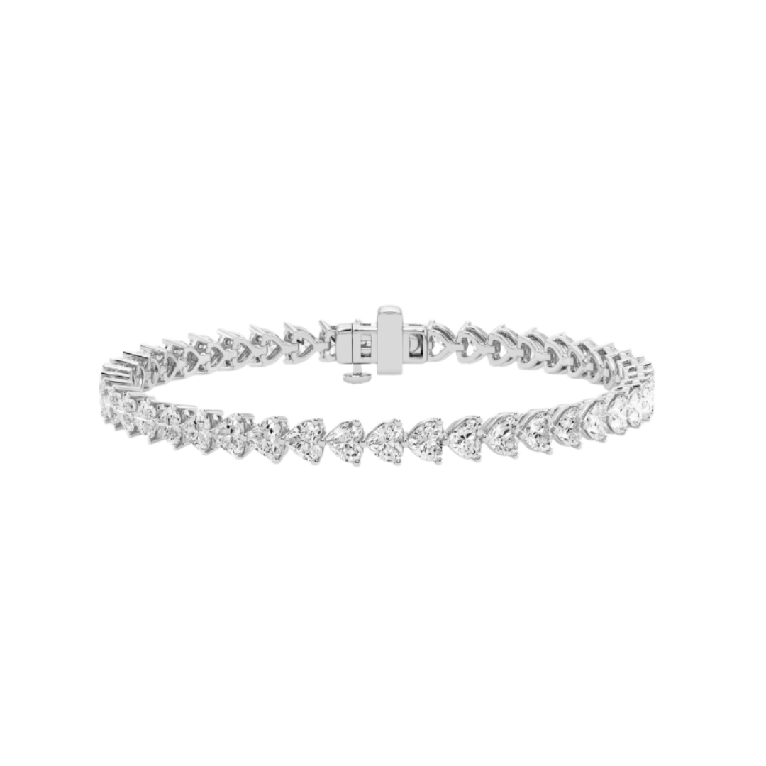 A gold tennis bracelet featuring a continuous row of heart-shaped diamonds, designed for elegance and romantic sophistication.