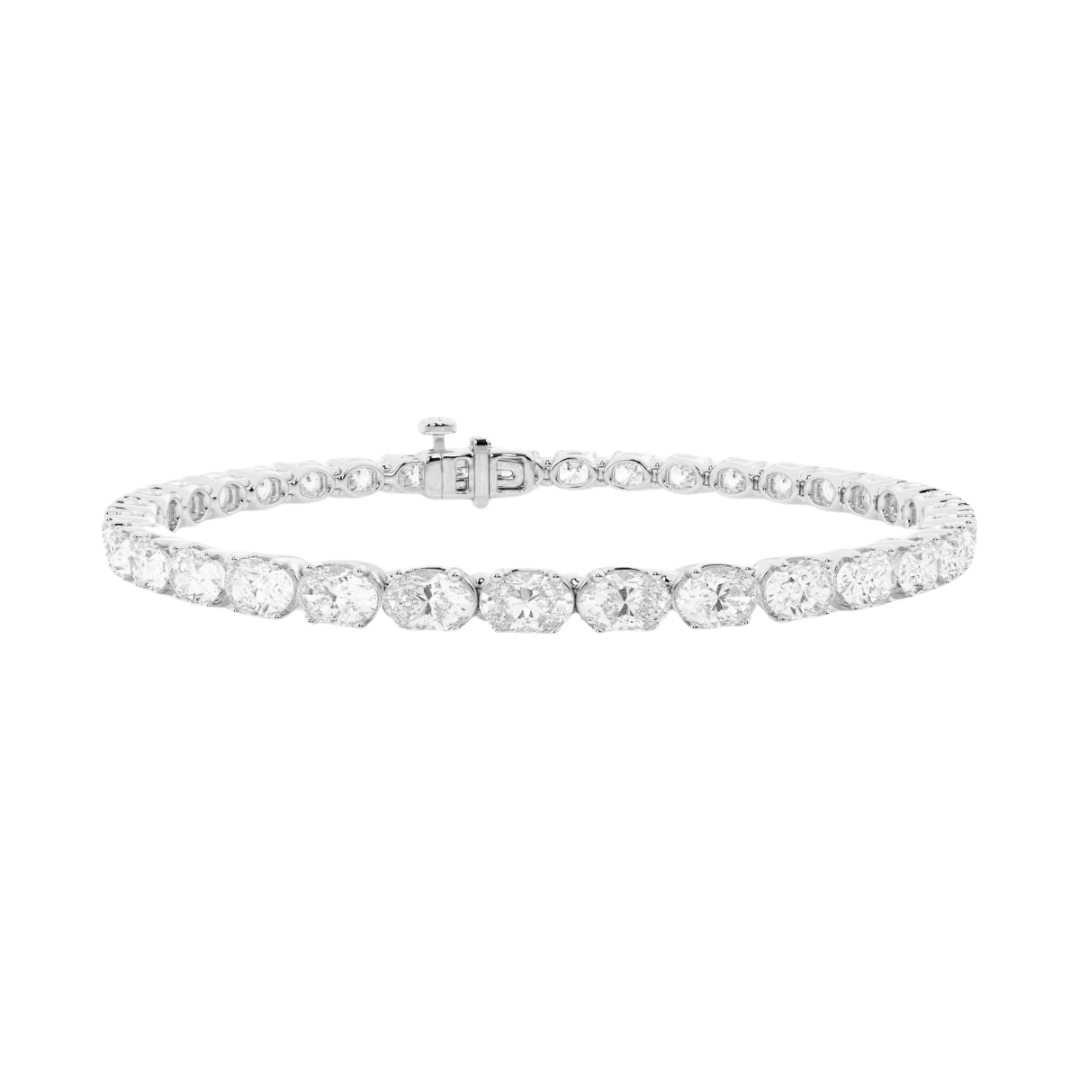 Oval diamond east to west tennis bracelet available in 5 carat and 10 carat total weight, featuring a sleek and modern design set in 14k