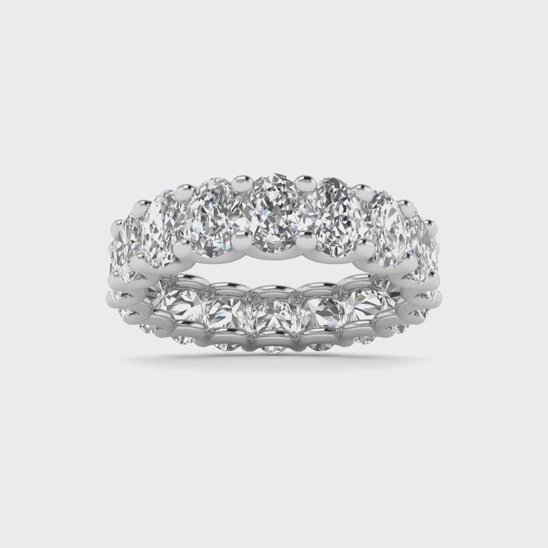 Oval diamond eternity band with 5 carat total weight, featuring a seamless row of sparkling oval-shaped diamonds in an elegant and timeless design.