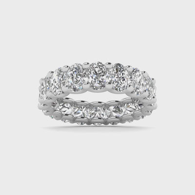 Oval diamond eternity band with 5 carat total weight, featuring a seamless row of sparkling oval-shaped diamonds in an elegant and timeless design.