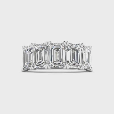Five stone emerald cut diamond ring featuring 5 carats total weight, with elegant diamonds set in a sleek and timeless band.