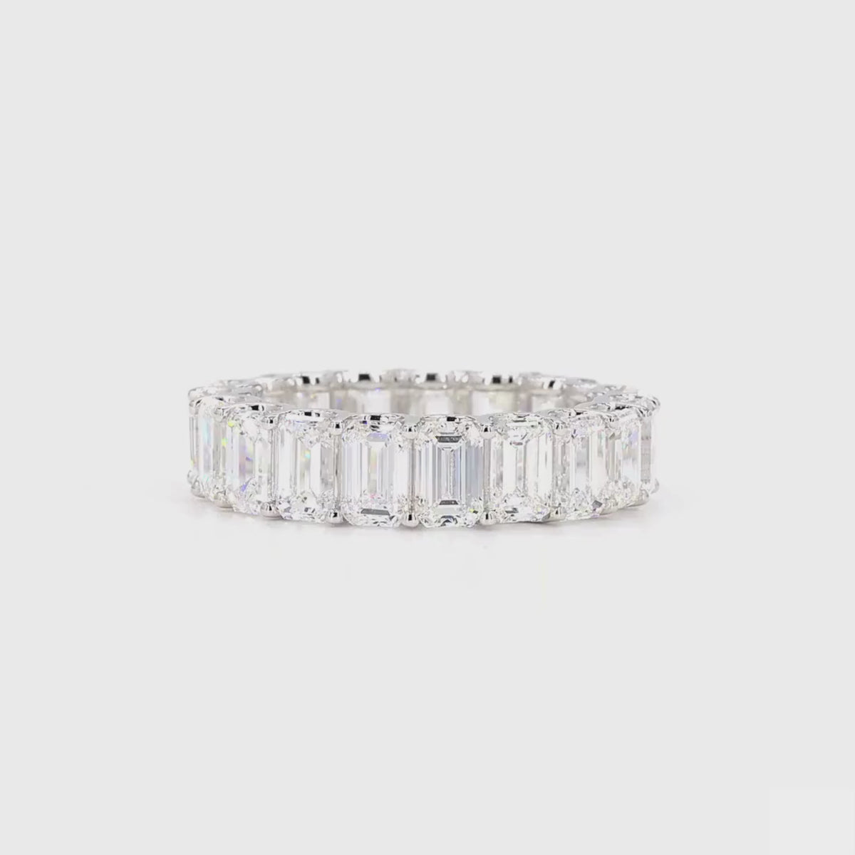360-degree view of an emerald cut diamond eternity band in white gold