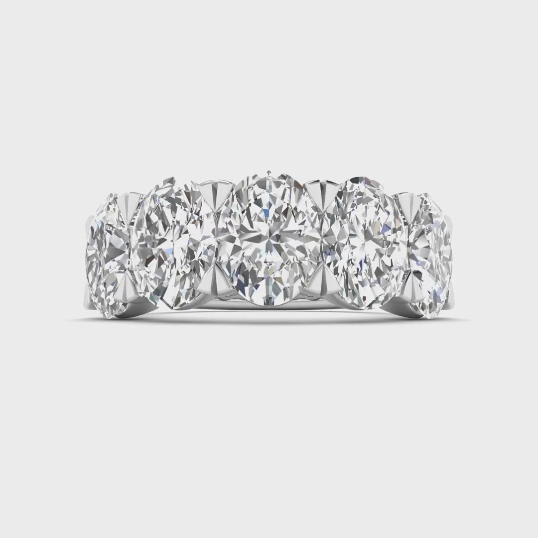 Five-stone ring featuring 5 carats of oval cut diamonds, elegantly set in a sleek band for a timeless and luxurious look