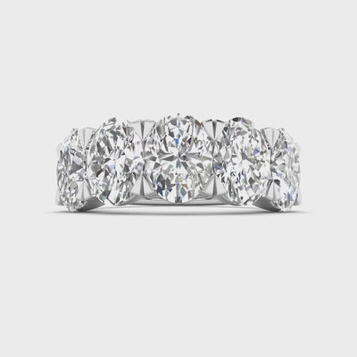 Five-stone ring featuring 5 carats of oval cut diamonds, elegantly set in a sleek band for a timeless and luxurious look