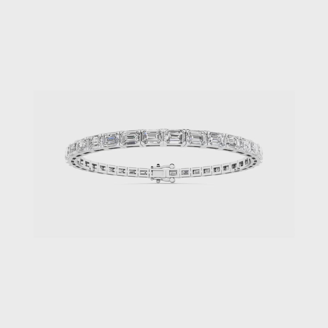 East to west emerald cut diamond tennis bracelet featuring brilliant emerald cut diamonds set horizontally in a sleek and elegant design.