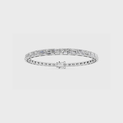 East to west emerald cut diamond tennis bracelet featuring brilliant emerald cut diamonds set horizontally in a sleek and elegant design.