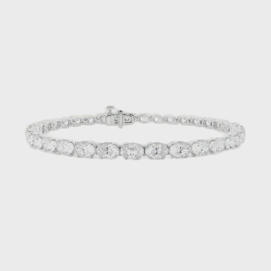 Oval diamond east to west tennis bracelet available in 5 carat and 10 carat total weight, featuring a sleek and modern design set in 14k