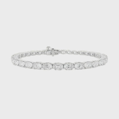 Oval diamond east to west tennis bracelet available in 5 carat and 10 carat total weight, featuring a sleek and modern design set in 14k