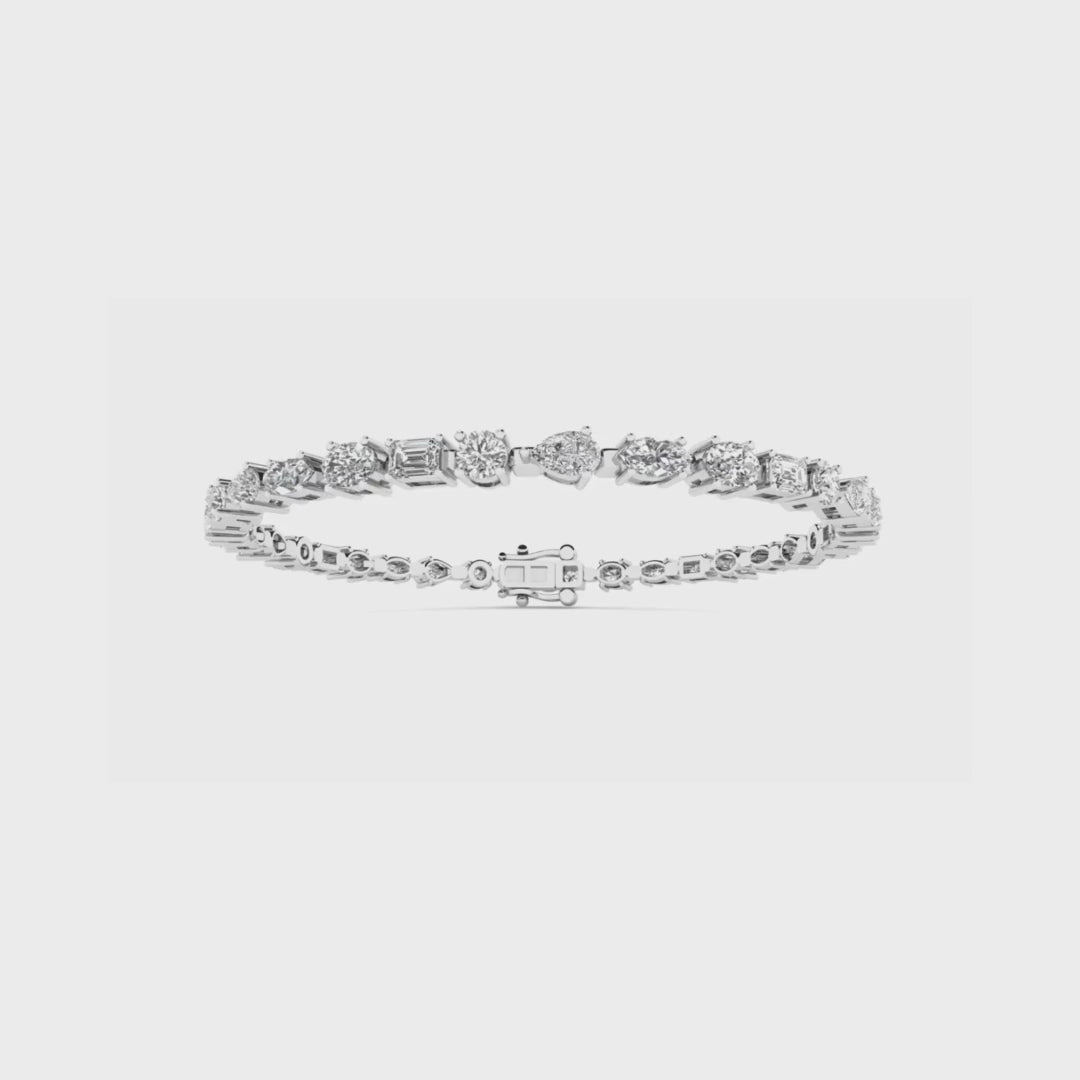 14K gold tennis bracelet featuring a seamless mix of pear, marquise, oval, emerald, and round-cut diamonds for a unique and elegant design.