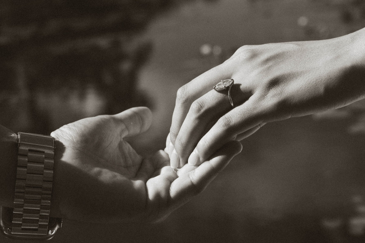 Couple holding hands wearing a custom engagement ring, Sakaris Jewelers serves clients across Southwest Florida and nationwide