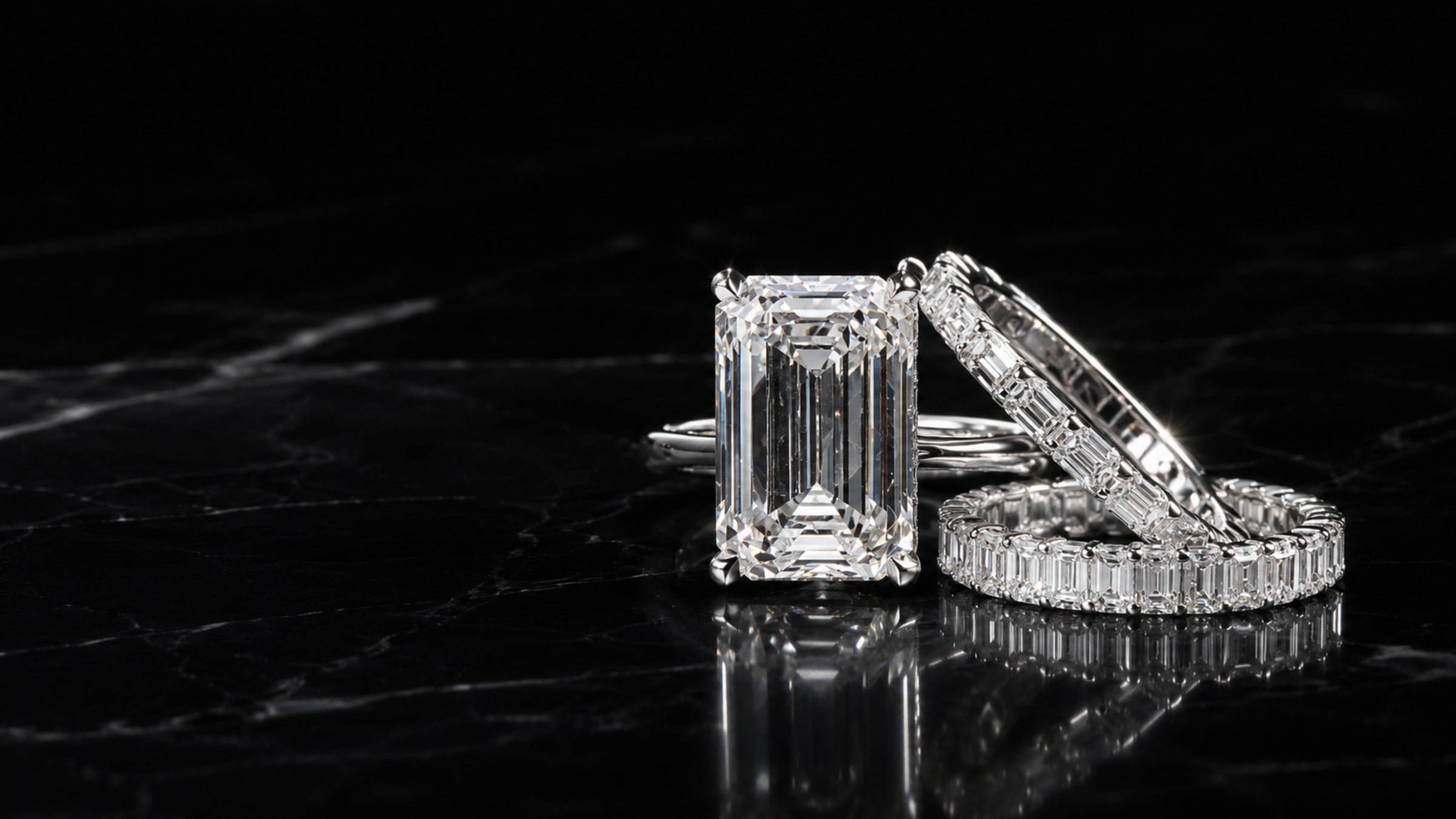 Platinum emerald cut engagement ring with matching diamond eternity wedding bands, custom designed by Sakaris Jewelers Naples Florida