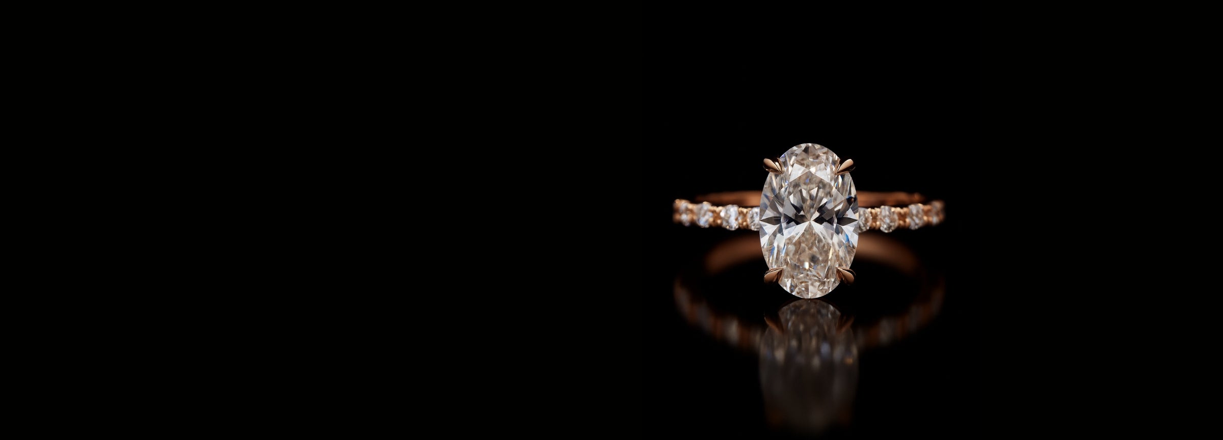 Oval diamond engagement ring in rose gold with pave band, custom designed at Sakaris Jewelers Naples Florida