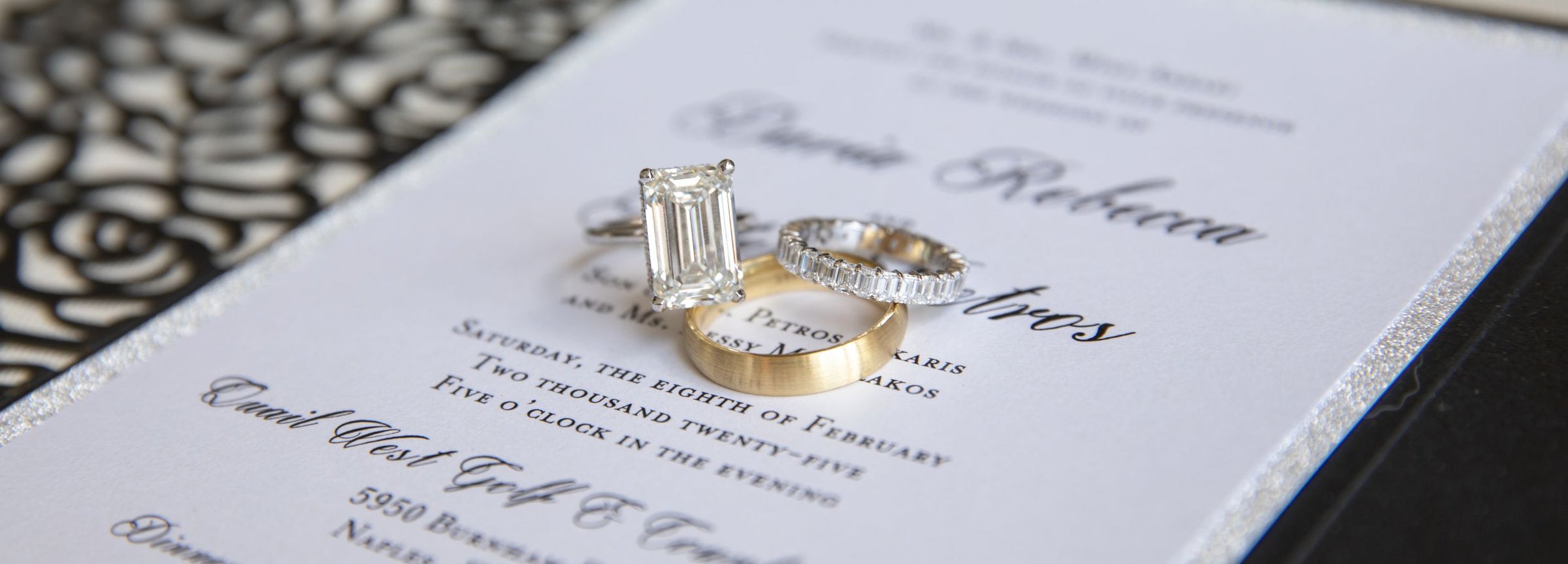 Custom wedding bands and diamond engagement ring on a Naples Florida wedding invitation &mdash; Sakaris Jewelers