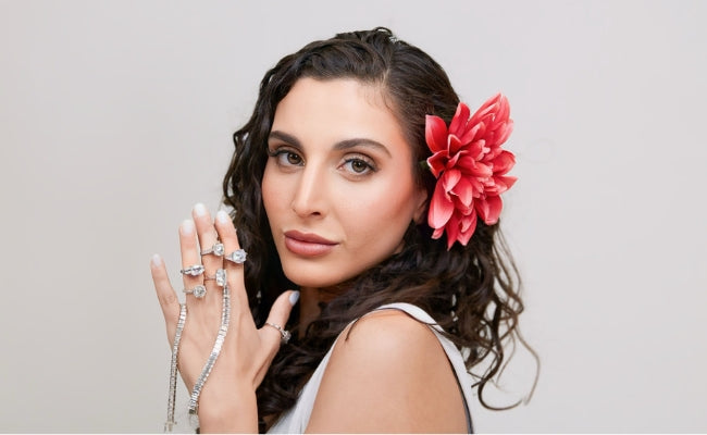 Model wearing stacked diamond engagement rings and a diamond tennis bracelet by Sakaris Jewelers, custom fine jewelry Naples Florida