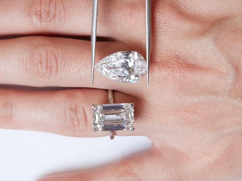 Pear and emerald cut diamonds being compared during a custom engagement ring consultation at Sakaris Jewelers Naples Florida