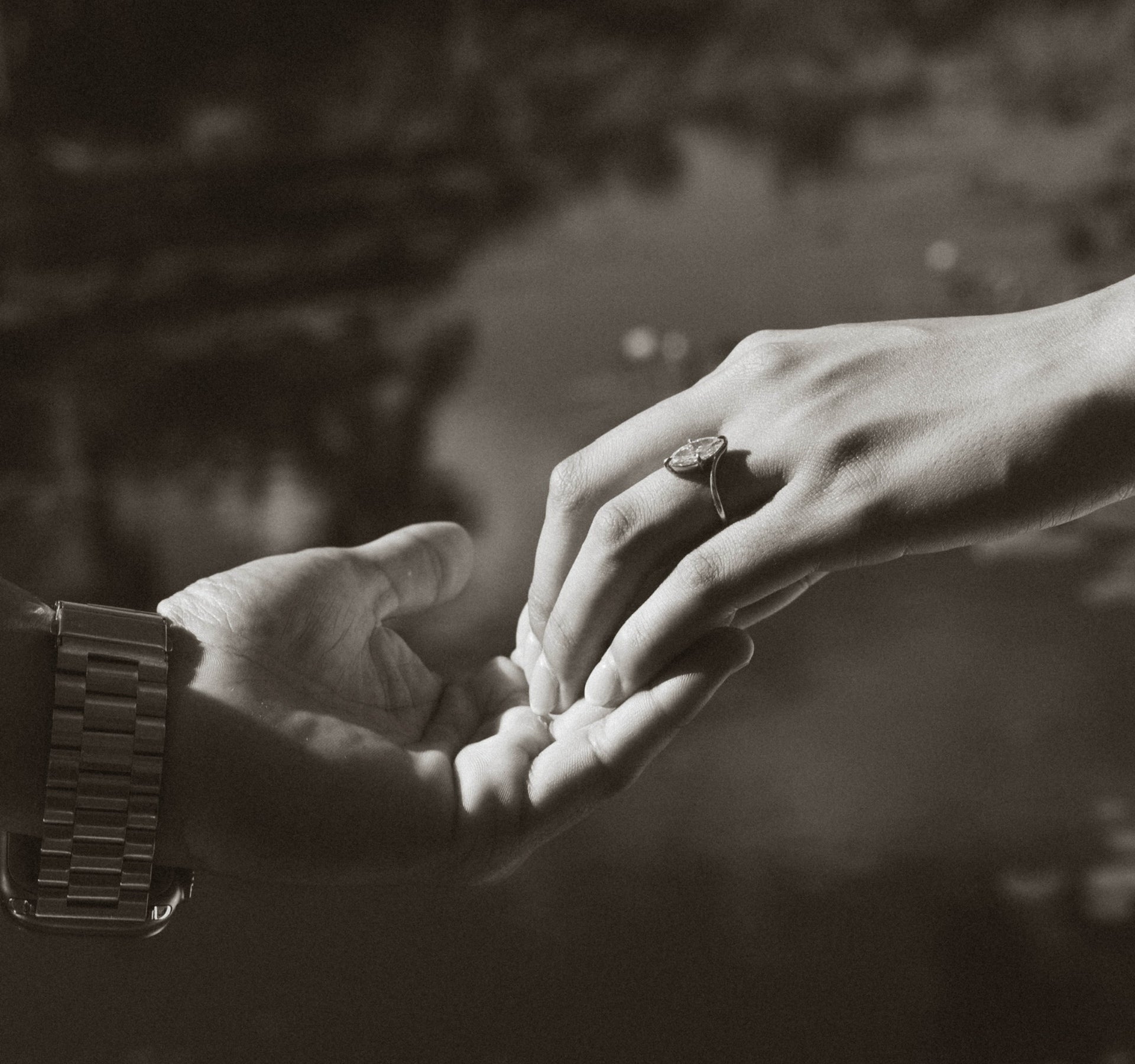 Couple holding hands after a marriage proposal, custom diamond engagement ring by Sakaris Jewelers Naples Florida